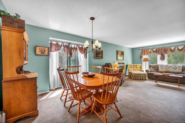 carpeted dining room with a chandelier, plenty of natural light, and a textured ceiling
