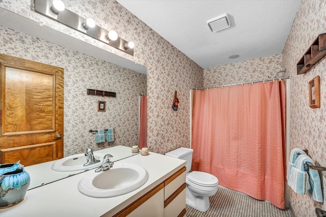 full bathroom featuring tile patterned floors, vanity, toilet, a textured ceiling, and shower / tub combo