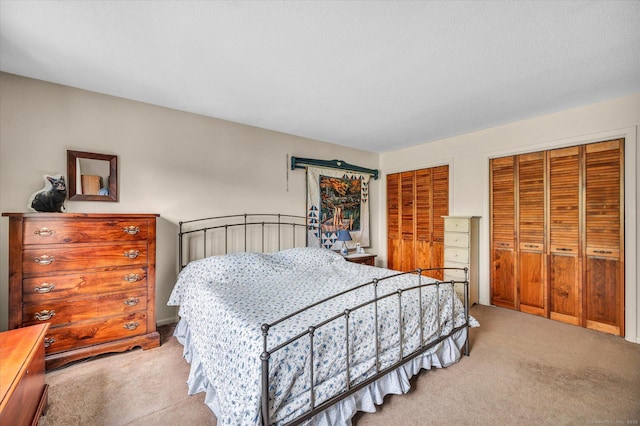 carpeted bedroom featuring two closets