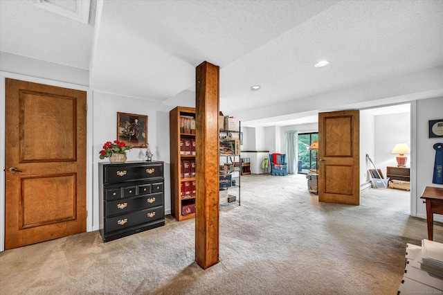 hall featuring carpet flooring, a textured ceiling, and recessed lighting