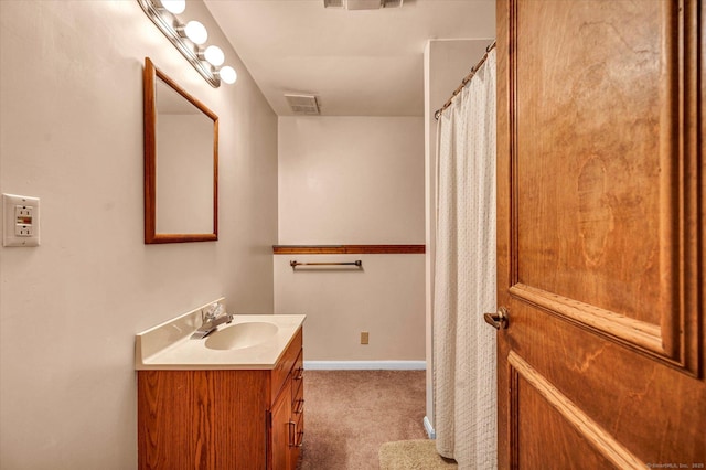 full bathroom with vanity and baseboards