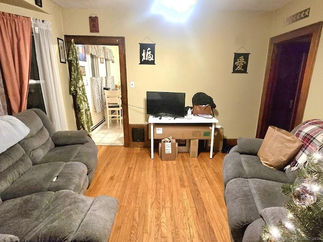 43 Westerly St, New Britain, CT 06053 - living room featuring a baseboard heating unit and light wood-style flooring