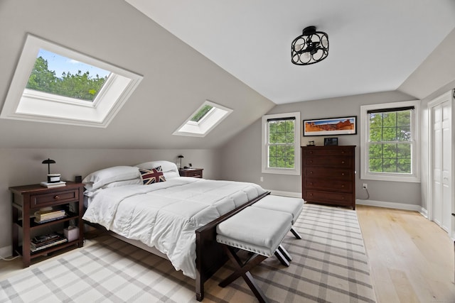 227 Sugar St, Newtown, CT 06470 - bedroom featuring a skylight, vaulted ceiling, light wood-style flooring, and baseboards