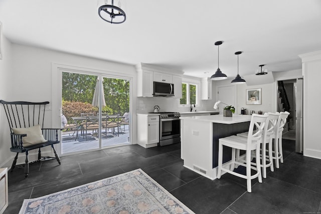 227 Sugar St, Newtown, CT 06470 - kitchen with stainless steel appliances, light countertops, and white cabinetry