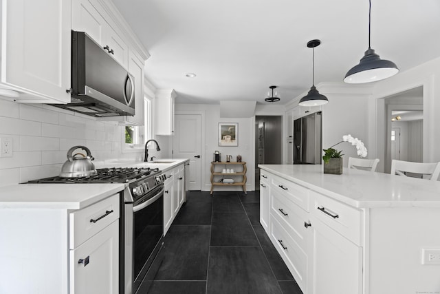 227 Sugar St, Newtown, CT 06470 - kitchen featuring gas range, a sink, tasteful backsplash, white cabinets, and light countertops
