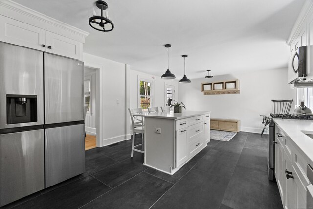 227 Sugar St, Newtown, CT 06470 - kitchen featuring stainless steel appliances, baseboards, white cabinetry, light countertops, and a breakfast bar