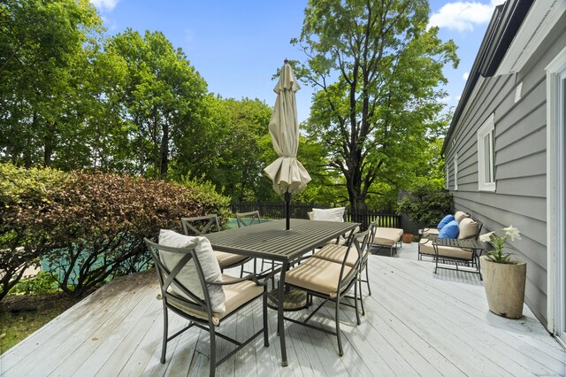227 Sugar St, Newtown, CT 06470 - wooden deck featuring outdoor dining space and view of wooded area