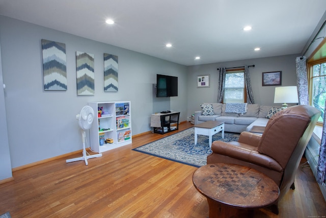 living room featuring recessed lighting, baseboards, and wood finished floors