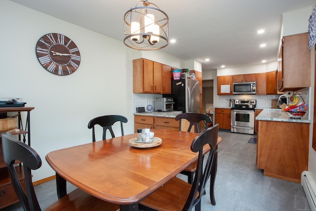 dining room featuring a notable chandelier, a baseboard radiator, recessed lighting, a toaster, and baseboards