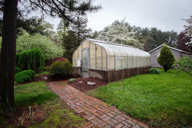 view of greenhouse with a yard