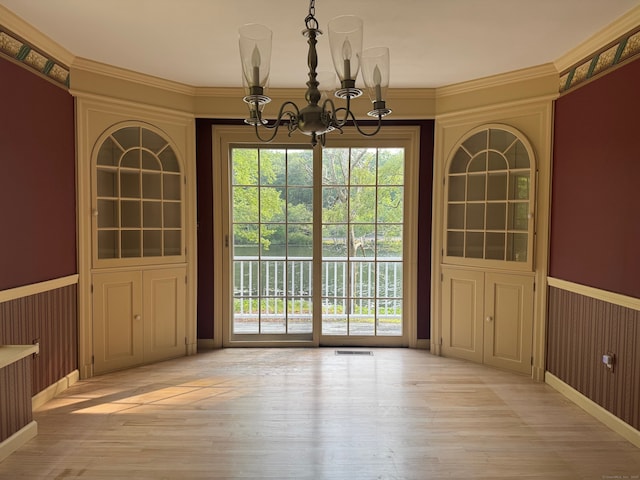 157 Pine Lake Rd, Westbrook, CT 06498 - unfurnished dining area featuring a chandelier, a wainscoted wall, and light wood-style flooring