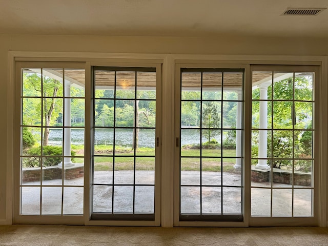 157 Pine Lake Rd, Westbrook, CT 06498 - doorway to outside featuring a water view, light colored carpet, and plenty of natural light