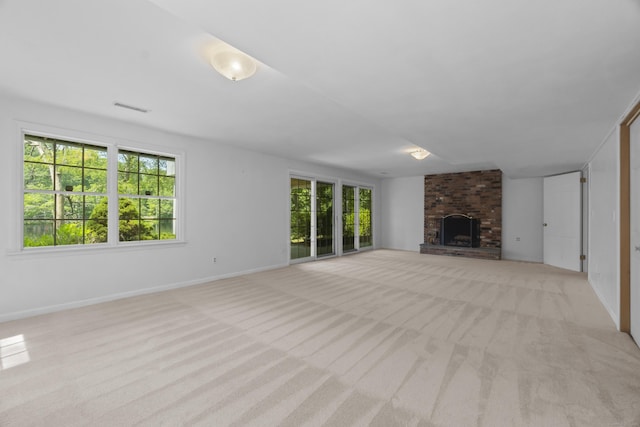 157 Pine Lake Rd, Westbrook, CT 06498 - unfurnished living room featuring light colored carpet and a brick fireplace