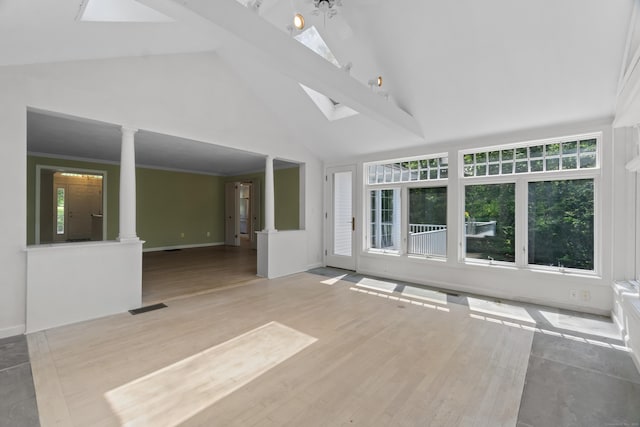157 Pine Lake Rd, Westbrook, CT 06498 - unfurnished living room with high vaulted ceiling, decorative columns, wood finished floors, and a skylight