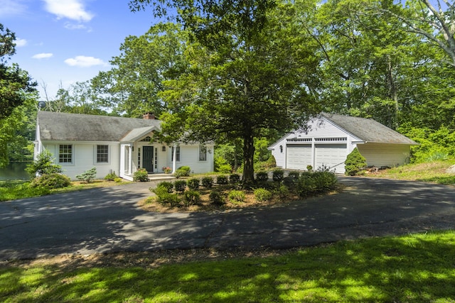 157 Pine Lake Rd, Westbrook, CT 06498 - view of front of home with driveway, a garage, an outdoor structure, and a chimney