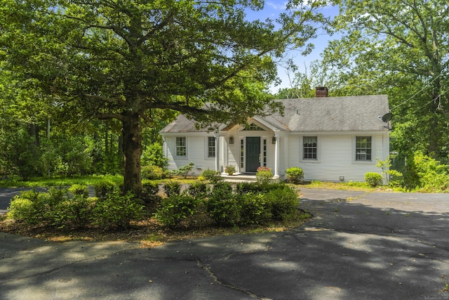 157 Pine Lake Rd, Westbrook, CT 06498 - view of front facade with a chimney, driveway, and a shingled roof