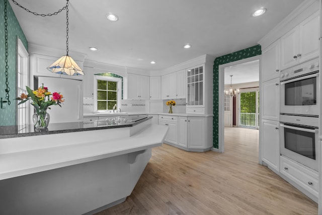 157 Pine Lake Rd, Westbrook, CT 06498 - kitchen with refrigerator, double oven, a chandelier, white cabinetry, and light wood-type flooring