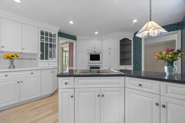157 Pine Lake Rd, Westbrook, CT 06498 - kitchen with white cabinets, white double oven, light wood-type flooring, glass insert cabinets, and hanging light fixtures
