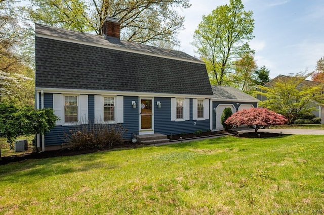 dutch colonial featuring roof with shingles, a chimney, central AC, an attached garage, and a front yard