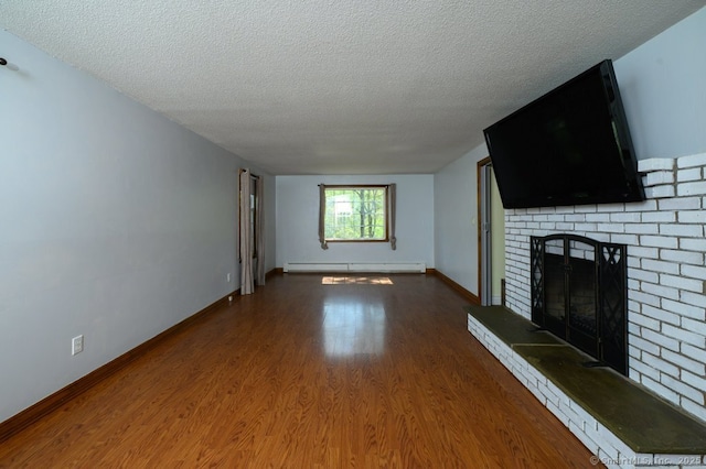 unfurnished living room with a baseboard radiator, a fireplace, a textured ceiling, wood finished floors, and baseboards