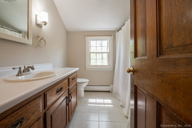 bathroom featuring baseboard heating, tile patterned floors, vanity, toilet, and lofted ceiling