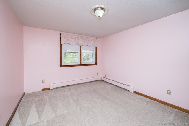 empty room featuring carpet flooring, baseboards, and baseboard heating