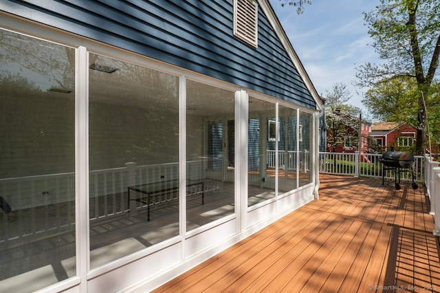 wooden terrace featuring a sunroom
