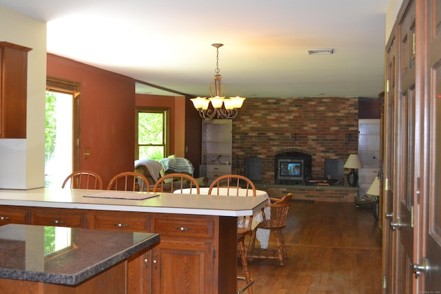 133 Music Vale Rd, Salem, CT 06420 - kitchen featuring brown cabinetry, a chandelier, dark wood finished floors, a peninsula, and open floor plan