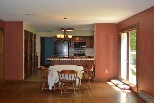133 Music Vale Rd, Salem, CT 06420 - dining room with a baseboard radiator, wood finished floors, a chandelier, and baseboards