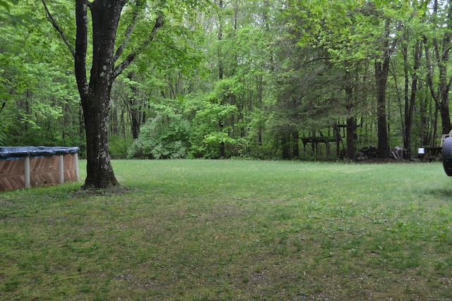 133 Music Vale Rd, Salem, CT 06420 - view of green lawn with a covered pool and a forest view