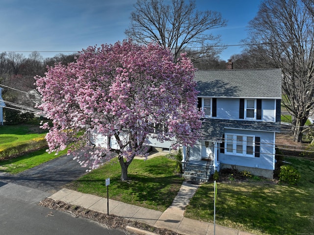 6 Thompson St, Fairfield, CT 06825 - view of front of home featuring roof with shingles, asphalt driveway, a front lawn, and a chimney