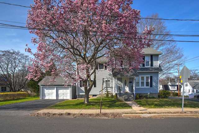 6 Thompson St, Fairfield, CT 06825 - obstructed view of property with driveway, a front yard, a garage, and a shingled roof