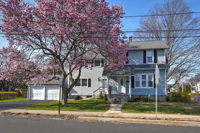 6 Thompson St, Fairfield, CT 06825 - view of front of house featuring a front yard, driveway, a chimney, and roof with shingles