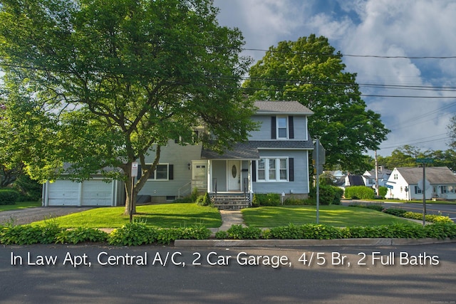 6 Thompson St, Fairfield, CT 06825 - view of front of house with a front lawn, asphalt driveway, and a garage