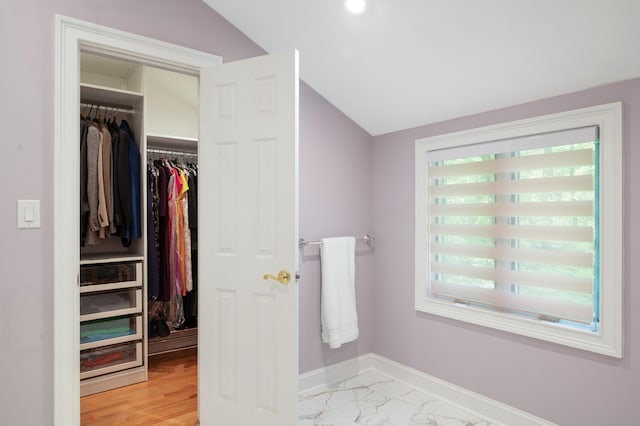 6 Shadow Ln, Norwalk, CT 06851 - bathroom with lofted ceiling, baseboards, and a walk in closet