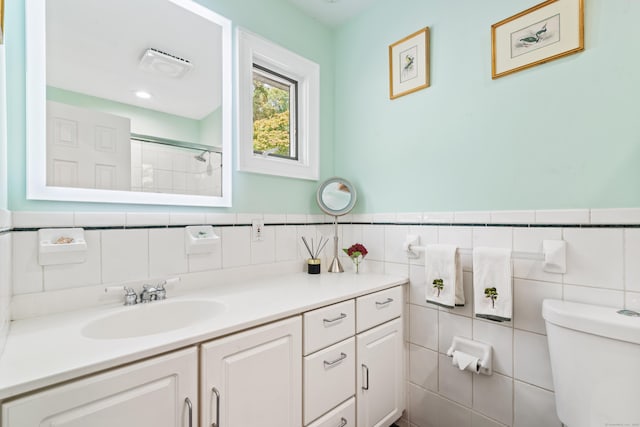 6 Shadow Ln, Norwalk, CT 06851 - bathroom with tile walls, toilet, vanity, a shower, and a wainscoted wall