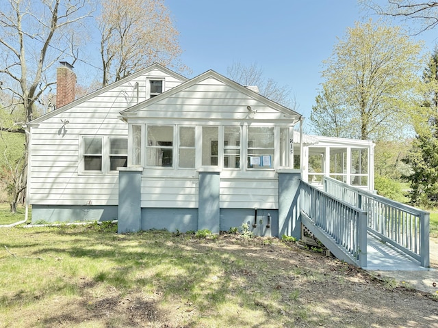 815 Alling Rd, Orange, CT 06477 - back of house with a sunroom, a chimney, and a yard