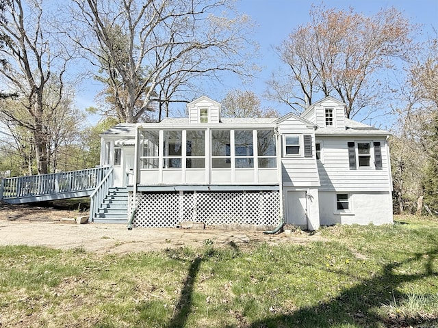 815 Alling Rd, Orange, CT 06477 - back of property with a sunroom, a deck, and a lawn