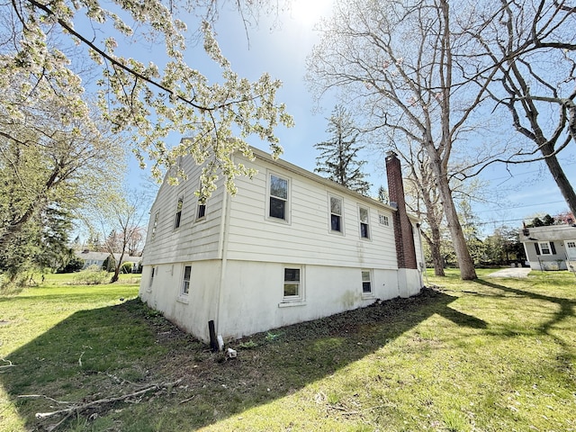 815 Alling Rd, Orange, CT 06477 - view of side of home with a chimney and a yard