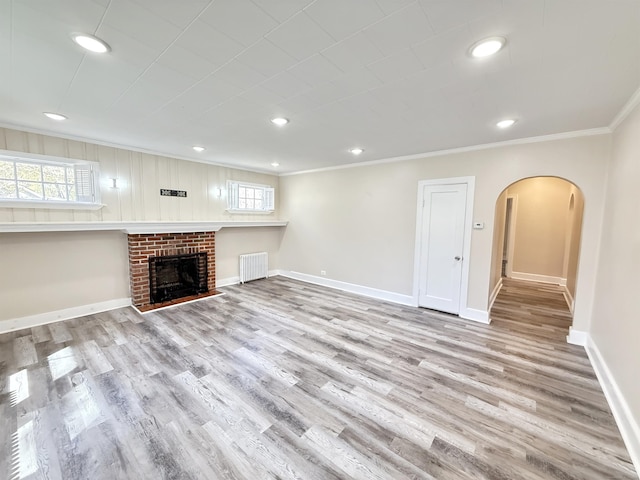 815 Alling Rd, Orange, CT 06477 - unfurnished living room featuring arched walkways, crown molding, wood finished floors, healthy amount of natural light, and recessed lighting