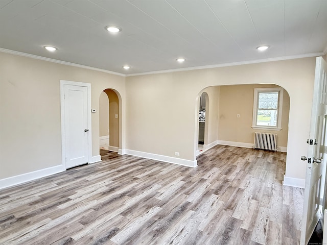 815 Alling Rd, Orange, CT 06477 - empty room featuring arched walkways, radiator heating unit, ornamental molding, light wood-style flooring, and recessed lighting
