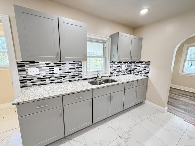 815 Alling Rd, Orange, CT 06477 - kitchen with gray cabinets, light marble finish flooring, arched walkways, and recessed lighting