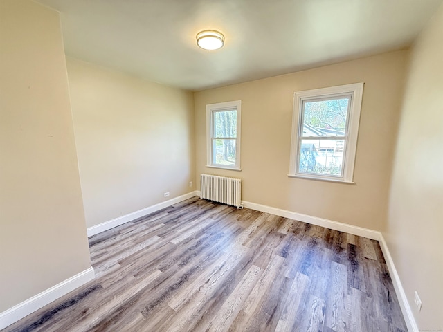 815 Alling Rd, Orange, CT 06477 - unfurnished room featuring radiator heating unit, wood finished floors, and baseboards