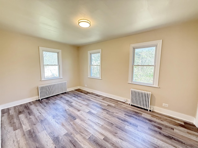 815 Alling Rd, Orange, CT 06477 - unfurnished room featuring radiator heating unit, wood finished floors, and baseboards