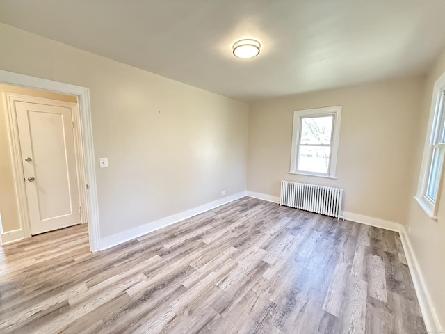 815 Alling Rd, Orange, CT 06477 - spare room featuring radiator, light wood-type flooring, and baseboards