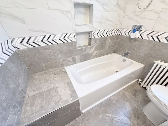 815 Alling Rd, Orange, CT 06477 - bathroom featuring radiator, a bath, toilet, marble finish flooring, and tile walls