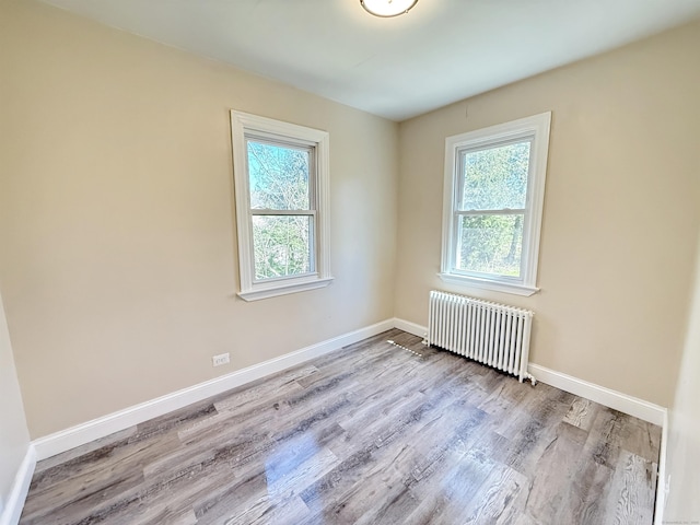 815 Alling Rd, Orange, CT 06477 - spare room featuring radiator heating unit, plenty of natural light, wood finished floors, and baseboards