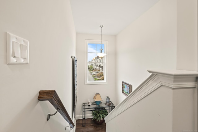 stairs featuring wood finished floors and baseboards