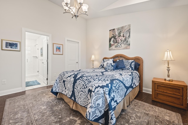bedroom featuring a chandelier, wood finished floors, lofted ceiling, baseboards, and ensuite bath