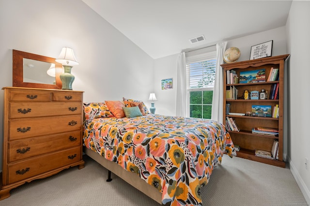 carpeted bedroom featuring vaulted ceiling and baseboards